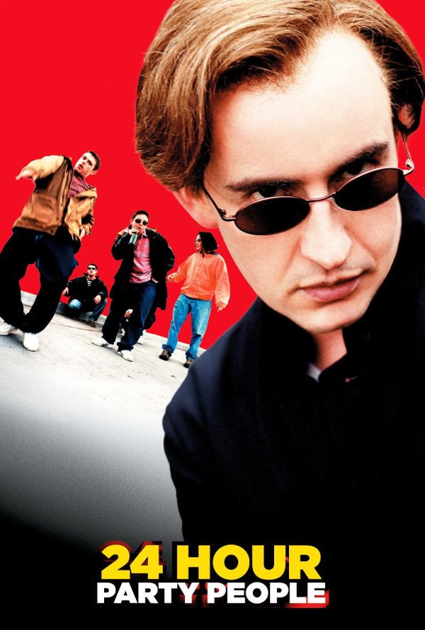 Poster for 24 Hour Party People: a man in dark sunglasses and a dark jacket looks down at the camera, with a group of men behind him against a red background.