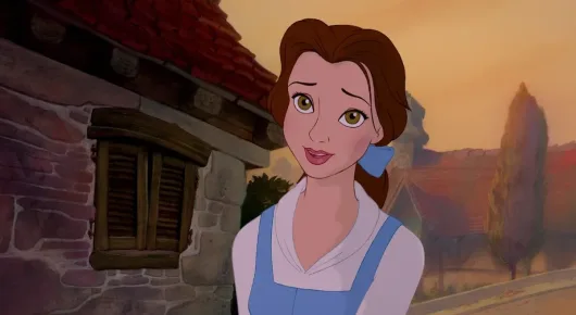 Still from Beauty and the Beast: animated Belle in a blue dress and white apron smiles in front of a village house.