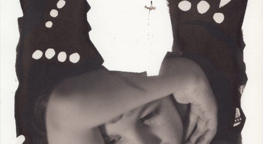Still from My Father and Qaddafi: a high-contrast close-up of a person with their head resting on their arm, in a polka-dot top.