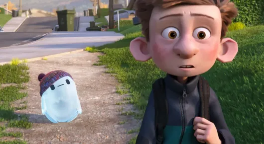 Still from Ron's Gone Wrong: an animated boy with a backpack looks worried beside a small white robot on a pavement.