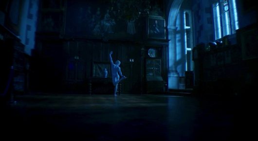 Still from The Painting and The Statue: a dim, blue-lit room with large windows and a small figure standing in the middle of the floor.