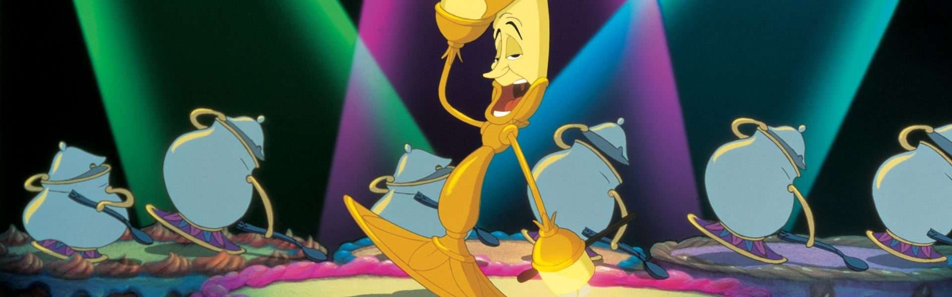 Still from Beauty and the Beast: an animated candelabra stands on a pink stage under green, purple and blue spotlights, with teapots and cups around him.